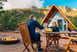 Couple toasting over table outside house